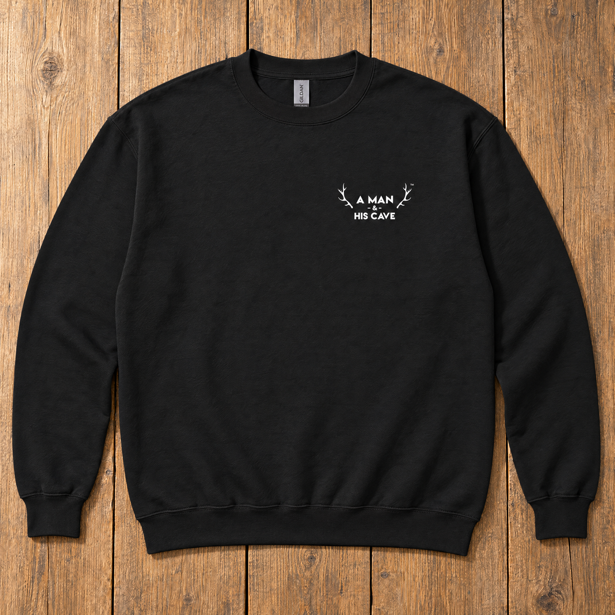 Black AMAHC logo crew sweatshirt laid flat on timber