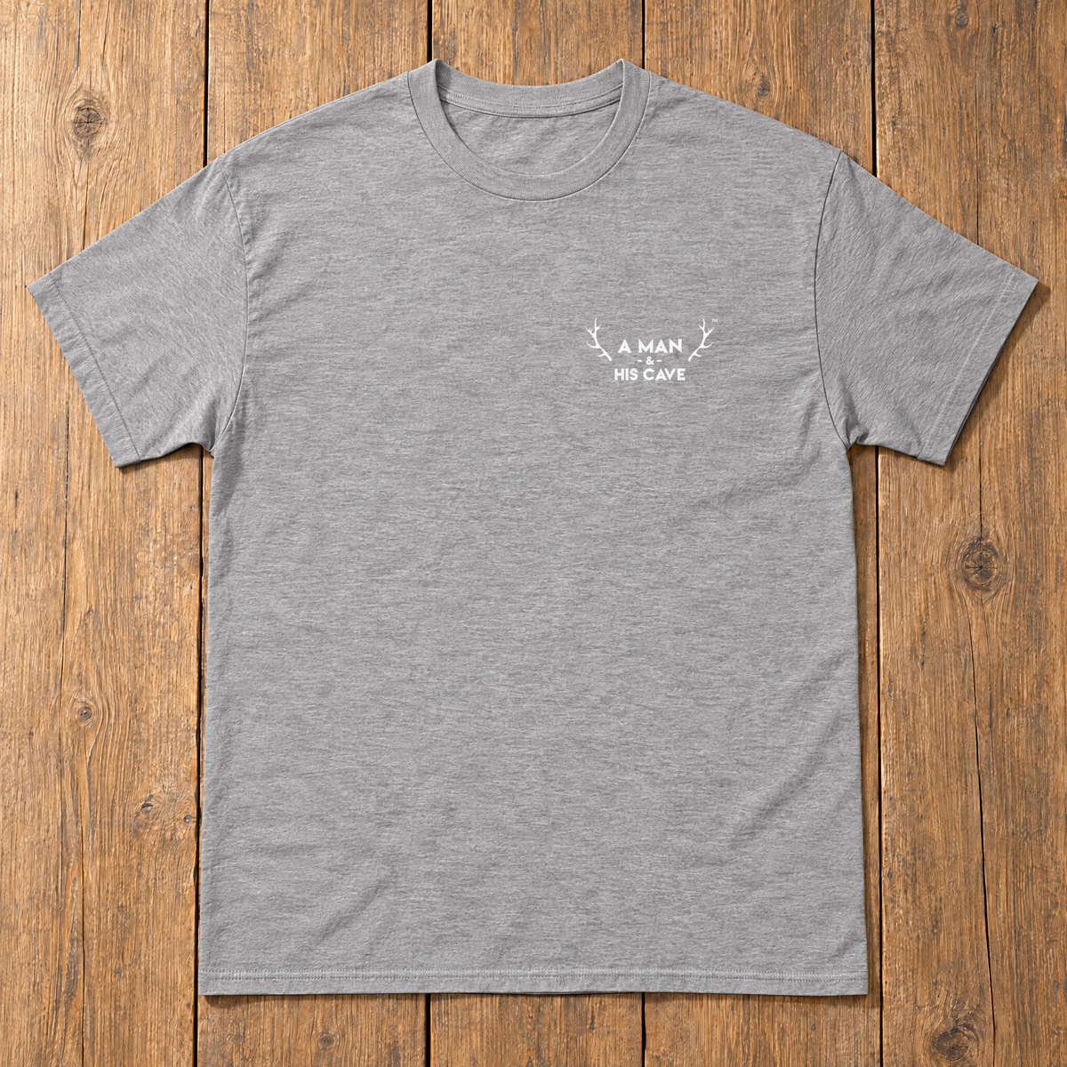 Grey AMAHC logo tee laid flat on timber