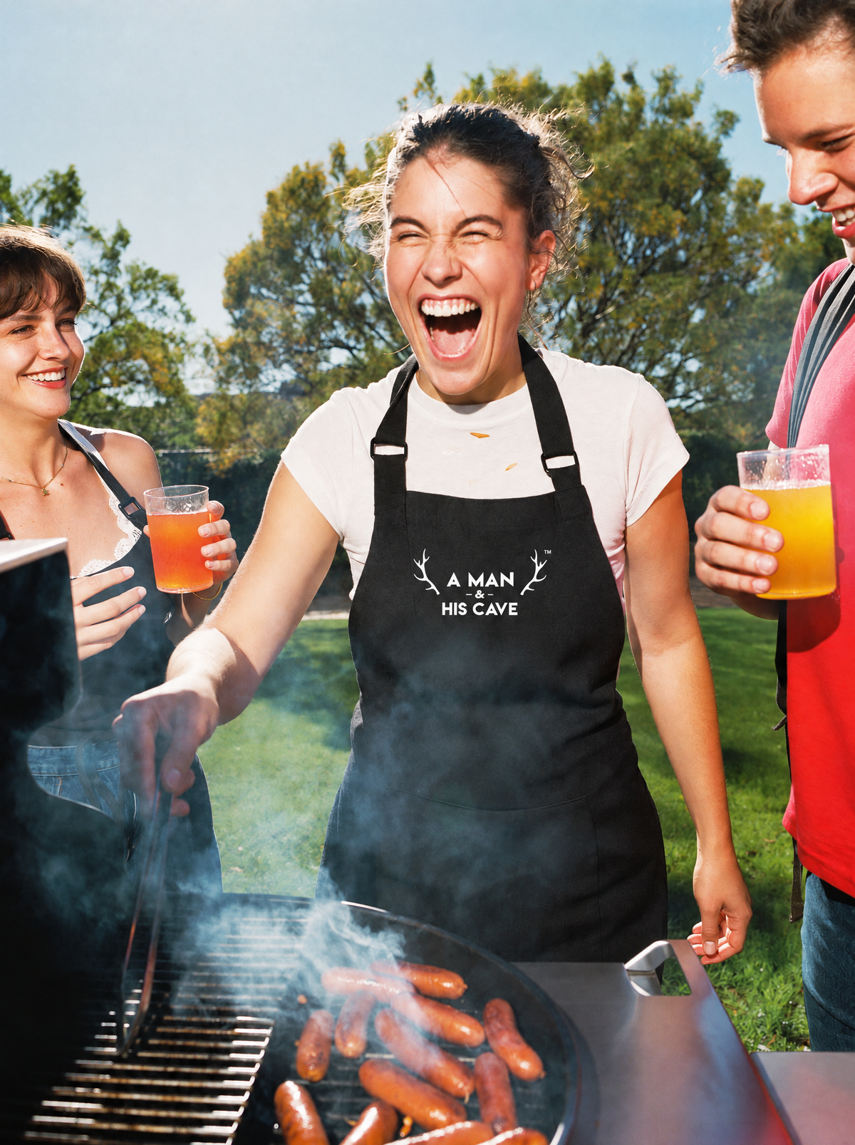 Woman on the barbecue tongs in the black AMAHC logo apron