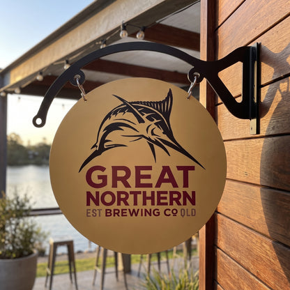 Great Northern round metal sign displayed on a riverside deck bar