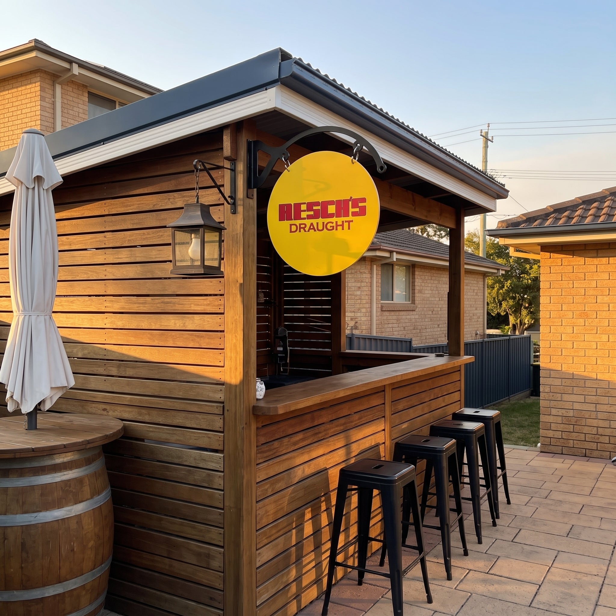 Resch's Draught round metal sign displayed on an outdoor timber bar