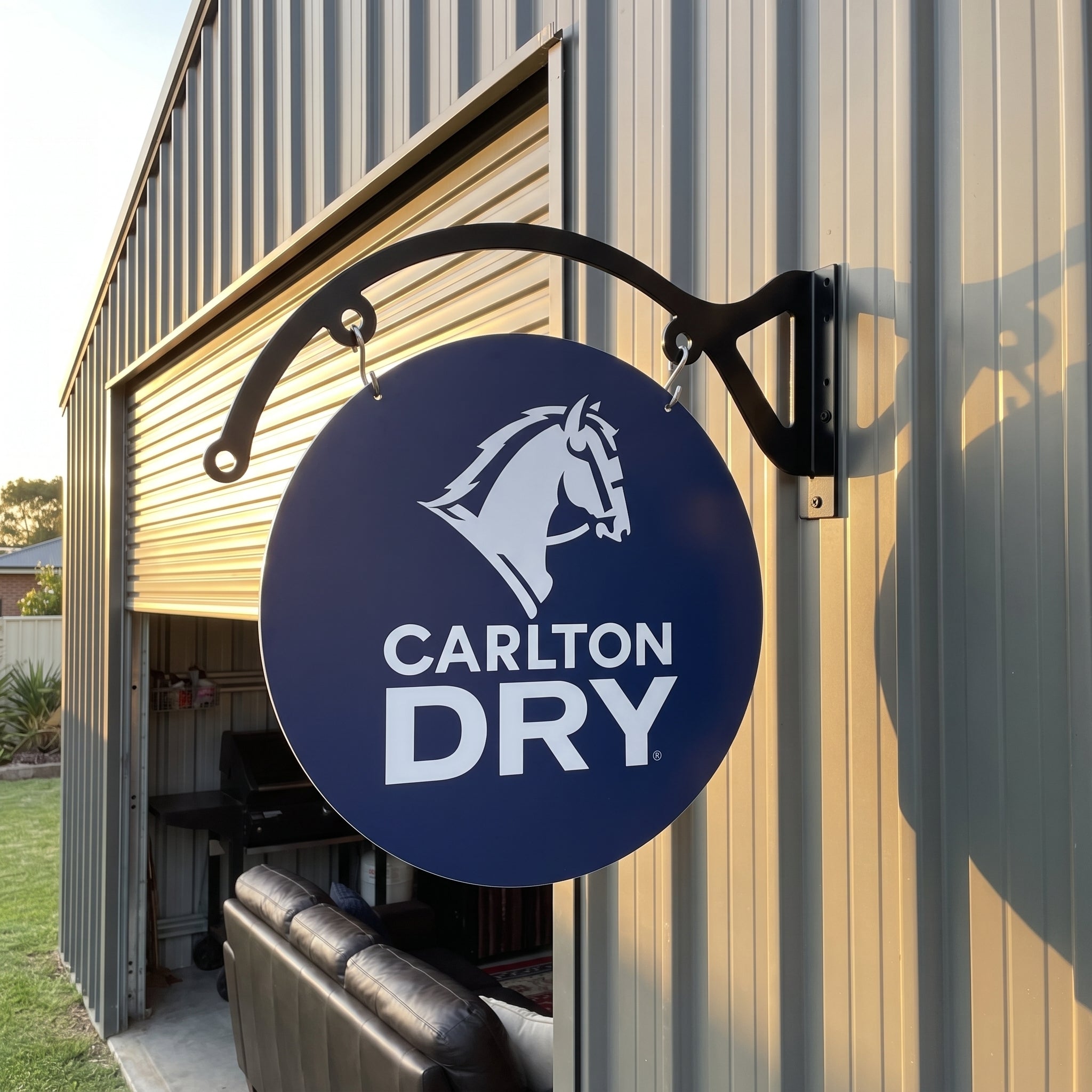 Carlton Dry round metal sign mounted on a shed exterior