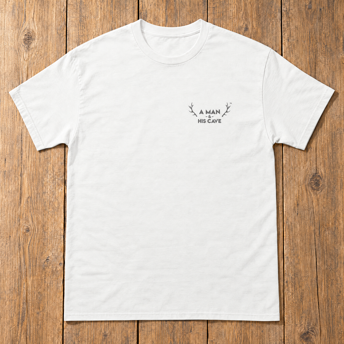 White AMAHC logo tee laid flat on timber