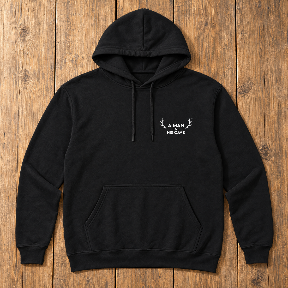 Black AMAHC logo hoodie laid flat on timber