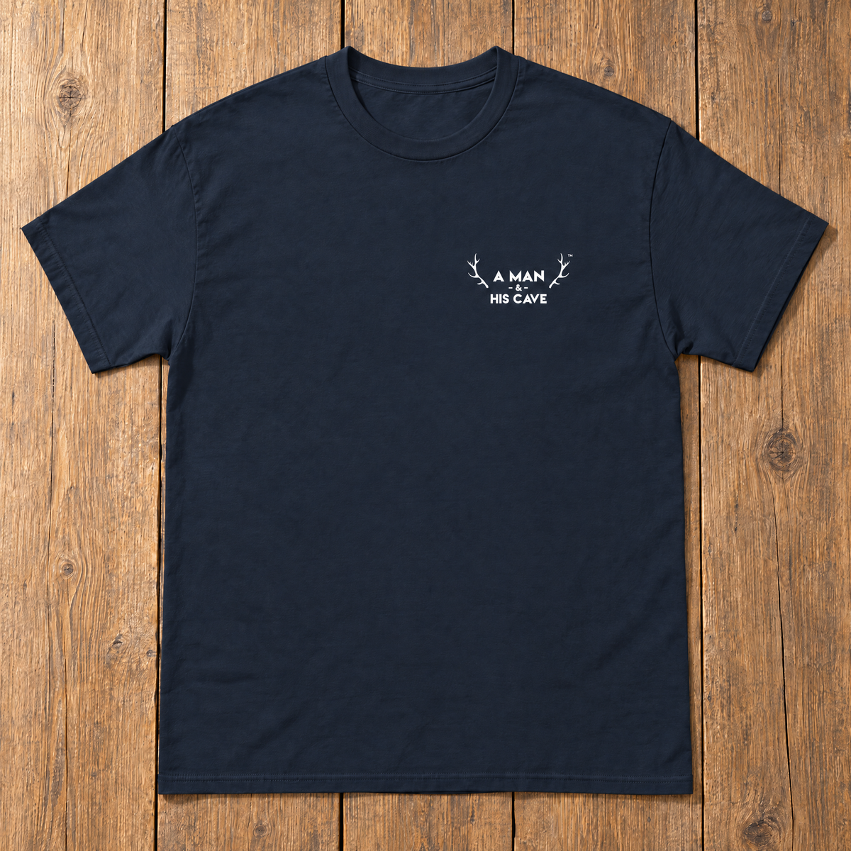 Navy AMAHC logo tee laid flat on timber