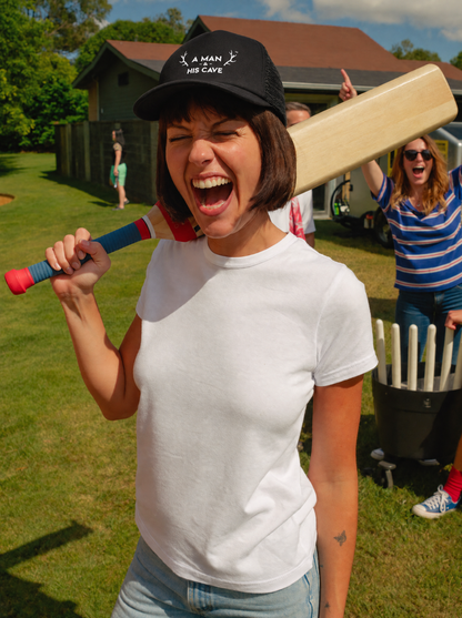 Woman laughing at backyard cricket in the black AMAHC logo trucker cap