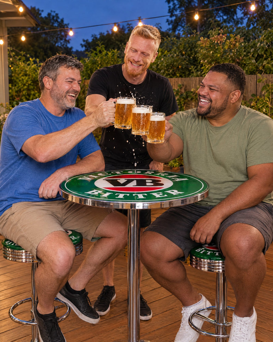 Three mates clinking beers over a VB bar table on VB stools at dusk